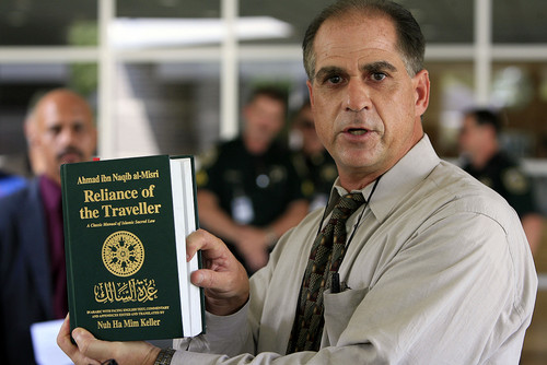 Alan Kornman of ACT for America holds a copy of Reliance of the Traveler, one of the most widely read and distributed manuals of Shariah Law,  during a press conference in support of 17-year-old Fathima Rifqa Bary.